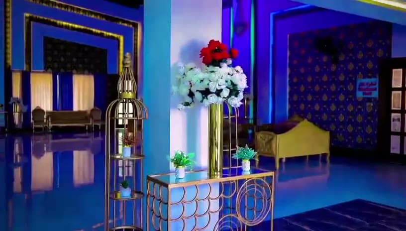 Raheem Events marquee interior with blue lighting and floral decor